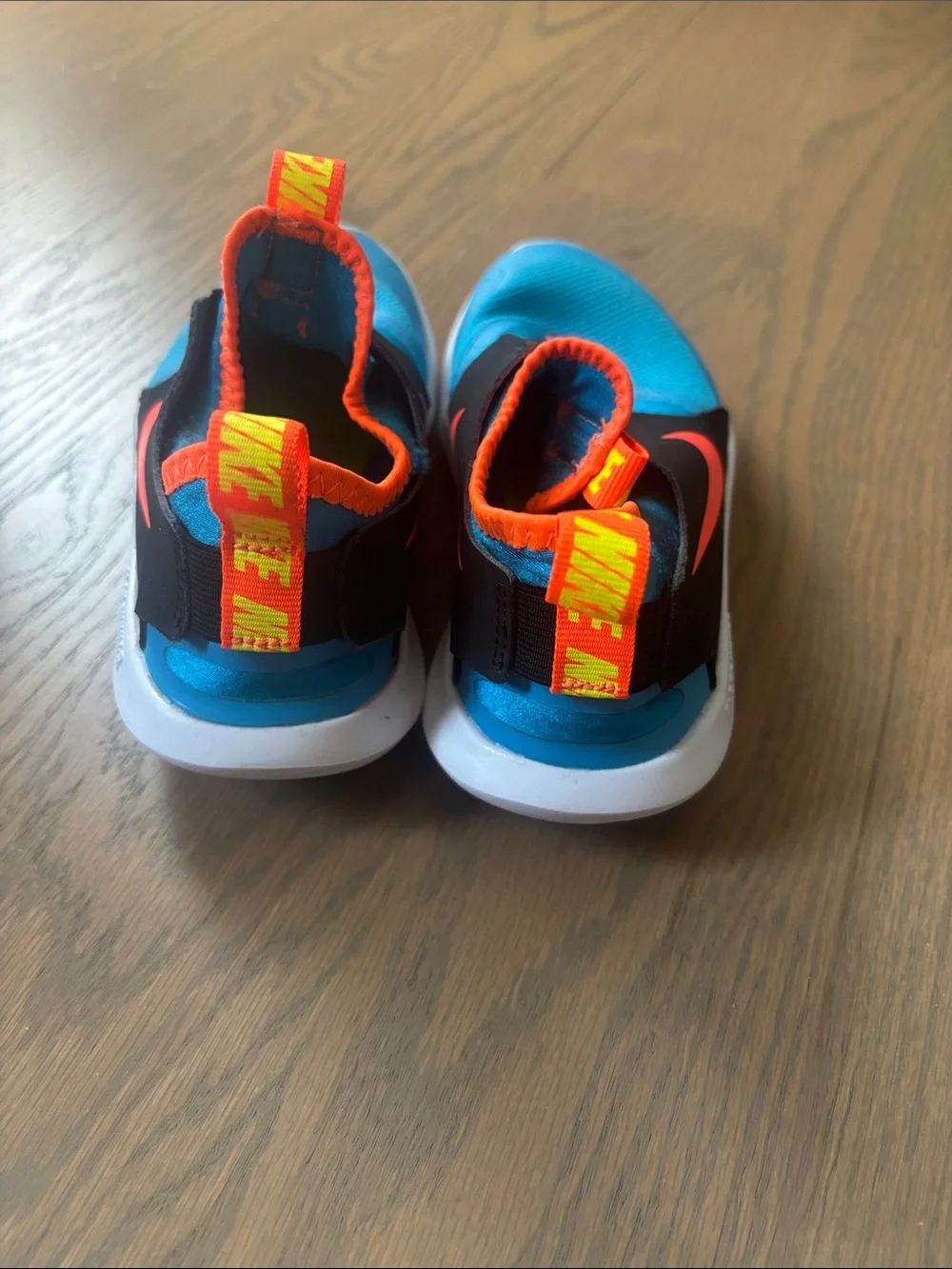 Nike Kids Slip-On Sneakers in Bright Blue with Orange Accents